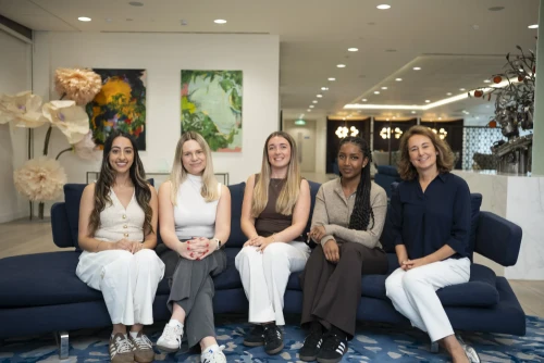 Early Careers team sitting on a sofa in a reception area.